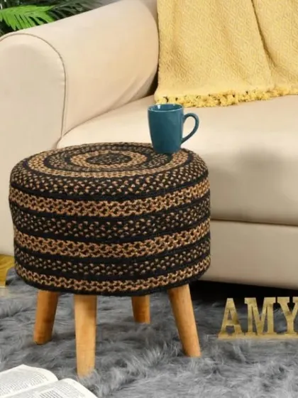 A sophisticated black and natural jute woven stool. The contrasting colors create a bold pattern that stands out in any setting.