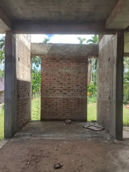 A view from inside the future living space, looking out onto the lush green farm.
