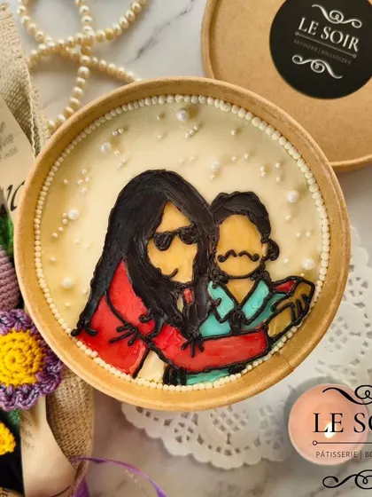 A personalized cake tub featuring a hand-painted portrait of a mother and child. It's a sweet and artistic way to send love in a small package.