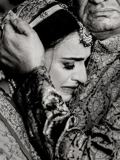The vidaai, or farewell. A daughter's emotional embrace with her father is one of the most powerful moments of a wedding day. I capture these raw, heartfelt goodbyes with sensitivity.