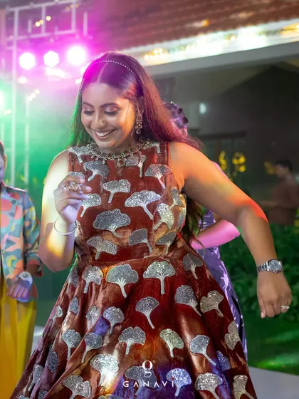 This custom rust-colored gown features a beautiful, shimmering pattern. It was designed to be comfortable enough for dancing while still looking absolutely splendid for a special event.