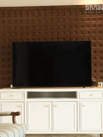 Our Sphere knobs on a white media console, set against a traditional carved wood panel. This shows how simple, classic hardware can bridge modern furniture and heritage decor.