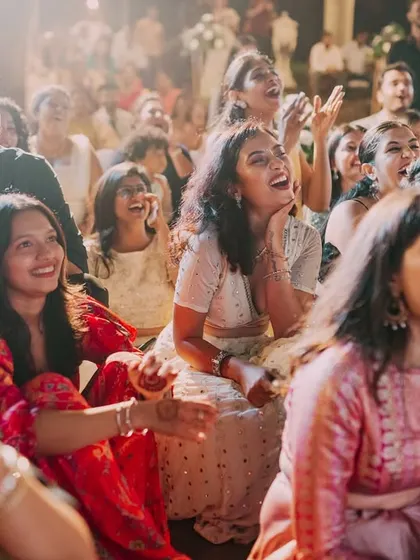 The pure, unadulterated laughter of guests watching the Sangeet performances. These reaction shots are just as important as the on-stage action for capturing the event's atmosphere.