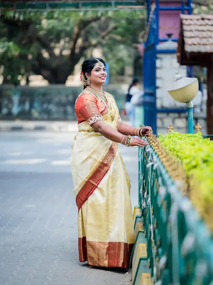 A lovely outdoor portrait of the bride in her traditional South Indian wedding attire.