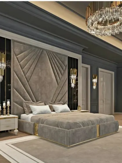 A grand bedroom design with a geometric upholstered headboard, flanked by statement wall sconces and a large crystal chandelier. The dark wall color adds to the room's dramatic and luxurious feel.