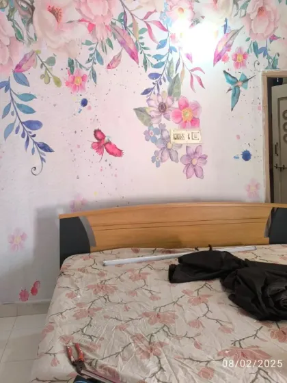 A custom watercolor-style floral mural in a bedroom. The soft colors and delicate design create a very feminine and artistic look.