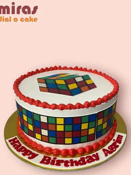 A fun and colorful cake based on the Rubik's Cube. This design is perfect for a puzzle lover, with the iconic colored squares decorating the top and sides.