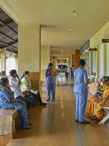 The outpatient waiting area at JSW Sanjeevani Hospital is an open, naturally ventilated veranda. This design moves away from enclosed, air-conditioned rooms, creating a more comfortable and less stressful environment for patients waiting for their appointments.