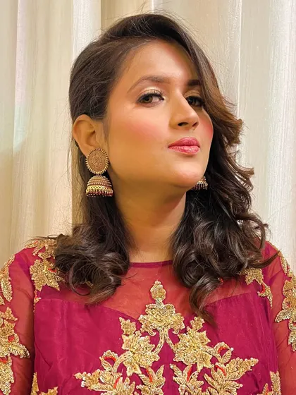 The final look, with soft waves and glowing makeup, ready for any celebration.