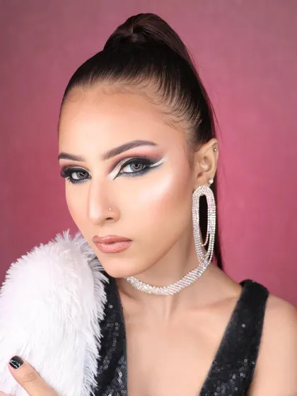 A powerful, direct gaze that showcases the intensity and creativity of the eye makeup.