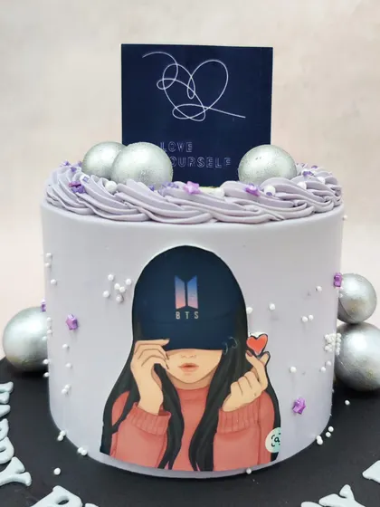 We celebrate the global phenomenon with this stylish BTS Army cake. Featuring fanart and the "Love Yourself" album logo on a chic lavender cake with silver accents, this design is a perfect tribute for any devoted fan's birthday.