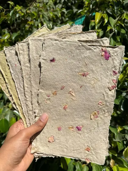 A stack of my latest batch of handmade paper, created from recycled newspaper and infused with dried rose petals. It's not perfect, but each sheet tells a story of transformation and learning.