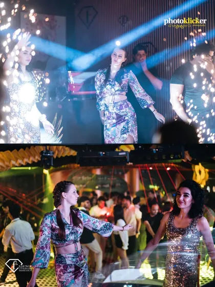 Dancers on the floor surrounded by guests and sparklers, highlighting the high-energy entertainment and celebratory moments we capture at club events.