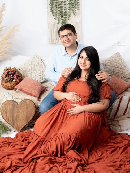 A classic family-to-be portrait on our boho set. The wooden heart prop adds a rustic and loving touch.