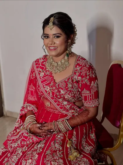A regal bride in red. We created a look with bold, soft kohl-rimmed eyes and lashes that cast a spell of elegance.