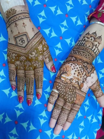 A truly unique design telling a story. One hand features a serene landscape with a tree and a peacock, while the other incorporates the sacred 'Om' symbol and lotus motifs.
