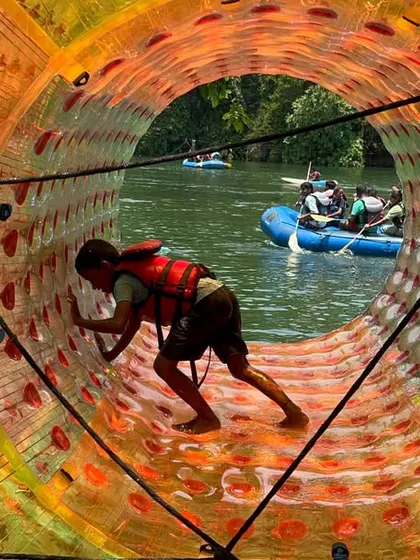 Fun on the water takes many forms. Here, a participant tries his hand at water rolling, a fun and challenging activity at our Dandeli camp.