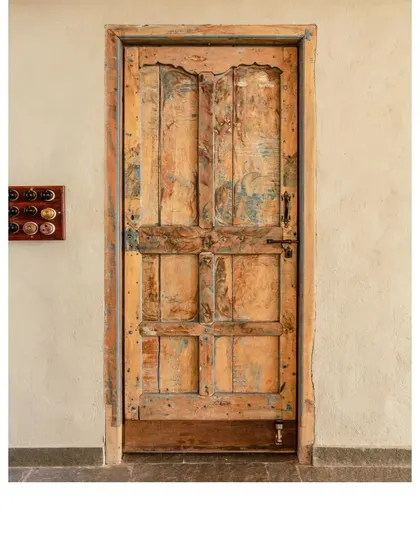 A weathered, painted door that shows layers of its past life. We chose this piece for its unique character and the story it tells.