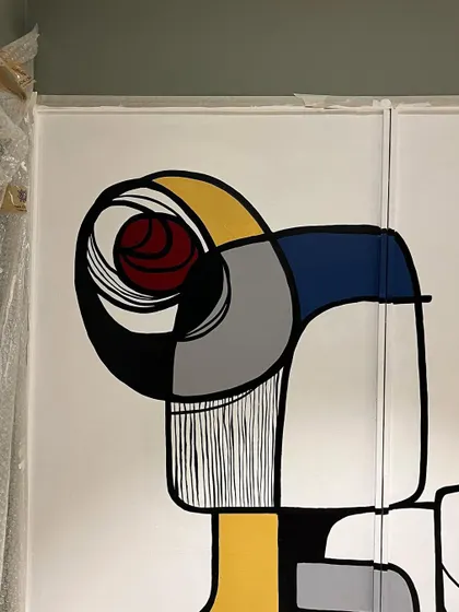 A close-up of the top section of the wardrobe, highlighting the clean lines and bold color blocking of the abstract design.