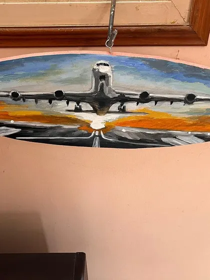 Fly high! I loved painting on this unique oval wooden canvas. This piece captures an airplane during takeoff, with the warm colors of the sunset reflecting on the runway. It’s a dynamic piece that evokes the excitement of travel and new beginnings.