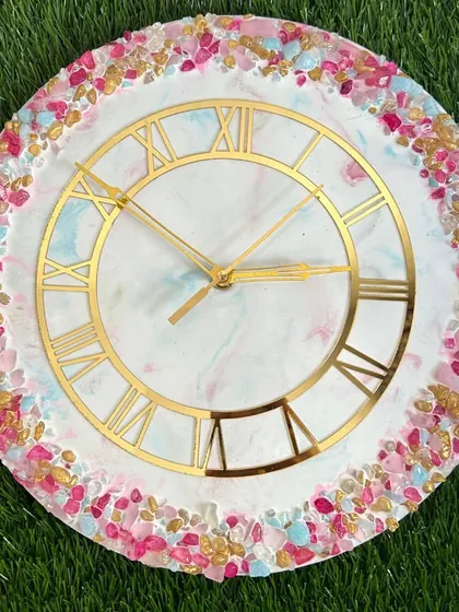 A playful and colorful resin clock with a border of pink, blue, and gold crystals. This shows how you can customize colors to create something truly unique.