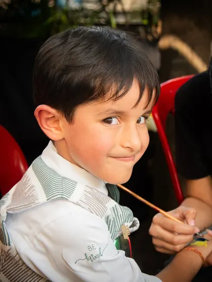 A cheeky smile from one of the party guests while getting a temporary tattoo. I focus on capturing the fun experiences of everyone at the event.