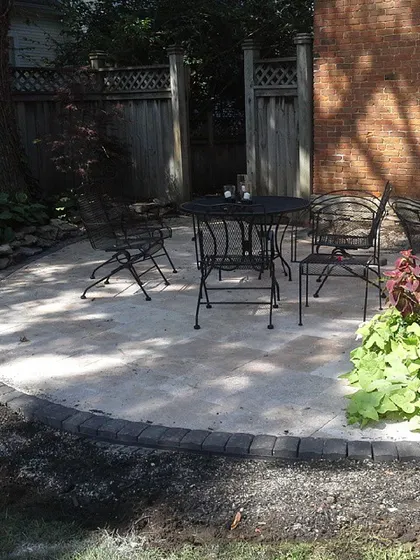 Even a small space can be turned into a useful patio. Here, I laid a simple circular patio with a dark paver border, creating a perfect spot for a small table and chairs.