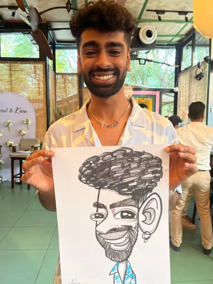 A guest at a wedding engagement party with a very expressive and fun caricature.