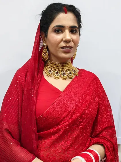 A basic, clean makeup look for this client in a traditional red saree. The makeup enhances her features without being overpowering.