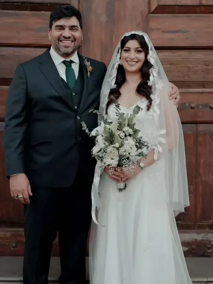 The happy couple posing in front of the church. Her simple and elegant bridal look is a perfect example of how less can be more.