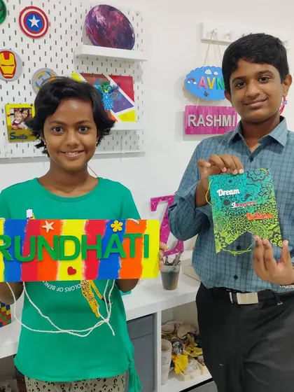 Cousins spending quality vacation time at our studio, creating a personalized nameplate and a decorative banner for their rooms.