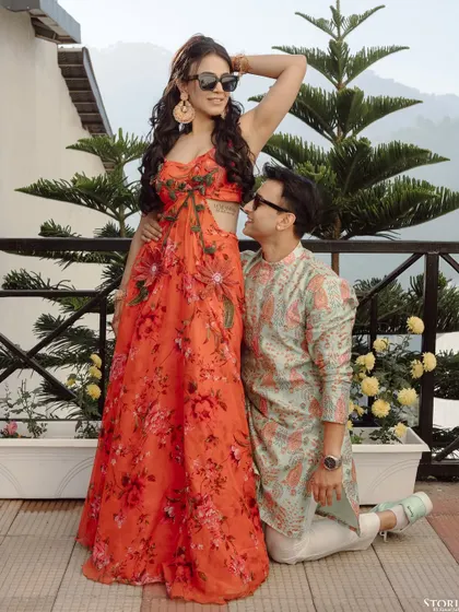 A fun and stylish pose on a balcony in Mussoorie, showcasing the couple's vibrant personalities and love for each other.