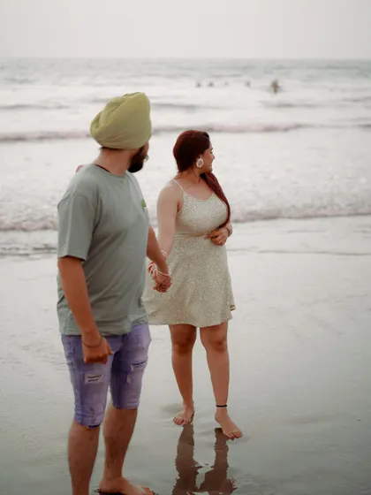 A candid shot of the couple enjoying the view of the ocean together. It captures a quiet, shared experience, reflecting on their journey.