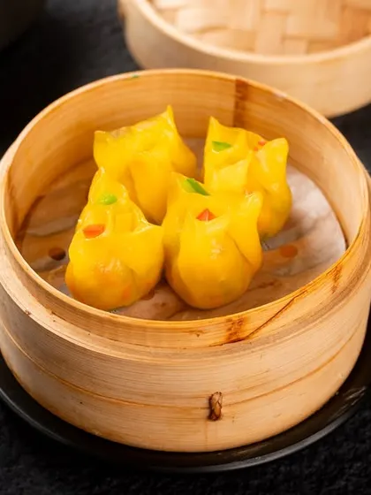 These cute, yellow, animal-shaped dumplings are fun and playful. A good photo helps convey their unique character on a crowded menu.