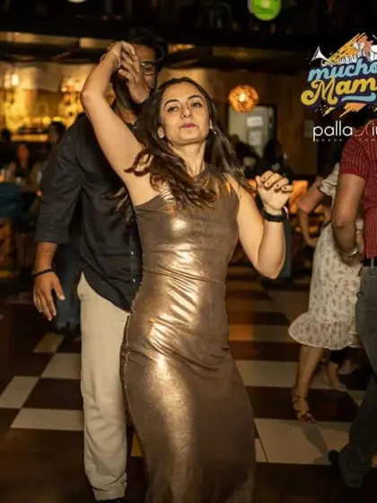 A dancer strikes a pose mid-movement. The energy on the floor is always high, encouraging everyone to express their individual style.