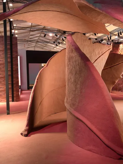 The monumental scale of the 'Terra' installation is evident in this shot, where the leaf forms curve and tower over the viewer, creating a truly immersive and architectural experience.