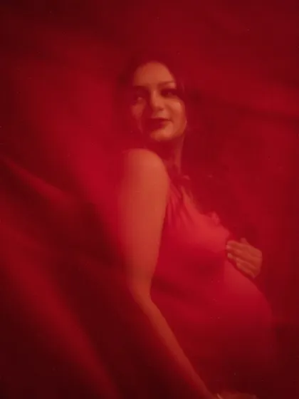 A fleeting glimpse of beauty. The motion blur and rich red tones in this shot create a sense of mystery and artistry, focusing on the feeling rather than perfect clarity.