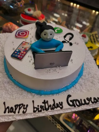 Another take on the workaholic theme, this cake includes a Dell laptop, a phone with apps, and other office elements. It's a funny and relatable cake for anyone who is always connected to their work.