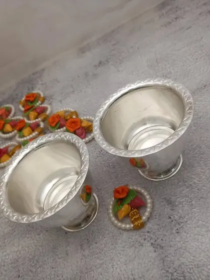 A pair of small German silver bowls with a twisted rope design on the rim. These are ideal for haldi and kumkum.
