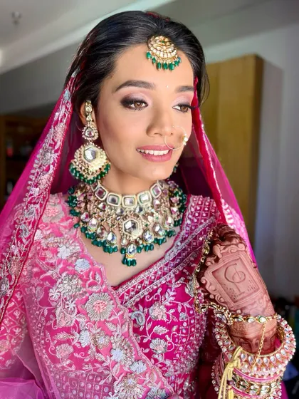This bride's smile says it all. The makeup is fresh and luminous, designed to make her feel comfortable and confident on her wedding day.