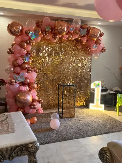 This wide shot shows how the rose gold sequin backdrop can transform a living room corner into a dedicated photo zone.