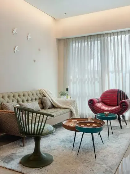 An eclectic living room from the Emaar DigiHomes project, featuring a mix of unique furniture pieces and wall decor.