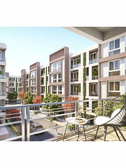 A view from a private balcony in the Green Valley development, overlooking the community's green spaces. We design homes to have a strong connection with their surroundings, ensuring residents can enjoy the thoughtfully planned landscape.