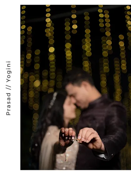 An artistic, out-of-focus shot of the couple about to kiss, with the engagement rings held in the foreground.
