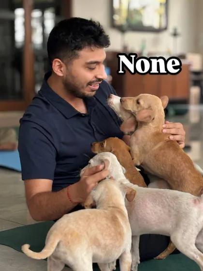 There's no such thing as too many puppies. A participant is covered in a pile of cuddling, playful pups.