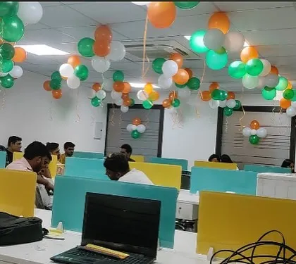 Office cubicles decorated with tricolor balloon garlands for Independence Day celebrations.
