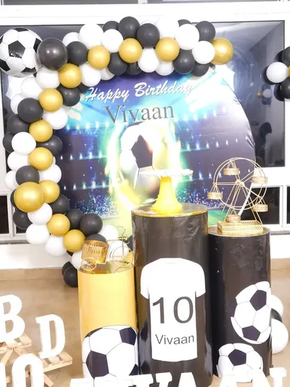 For the little football fan, this theme is a perfect score. I use a backdrop with a stadium graphic, custom printed pedestals, and a black, white, and gold balloon arch to create a sporty vibe.
