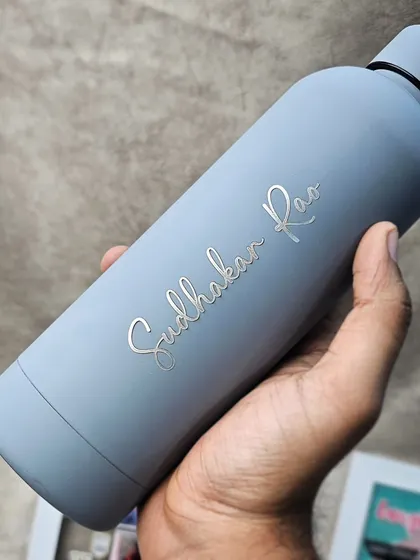 Duplicate of 53. The same Quench bottle style, this time personalized with an individual's name. The elegant script stands out against the smooth matte grey finish.