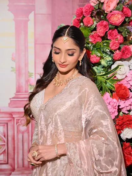 A soft and ethereal look for a day function, featuring a beautiful organza saree. The makeup is minimal yet impactful, with defined eyes and a natural glow.