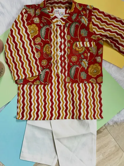 A perfect blend of tradition and style. This kurta set features a mix of floral and zigzag patterns in earthy red and mustard tones, crafted from the softest cotton.
